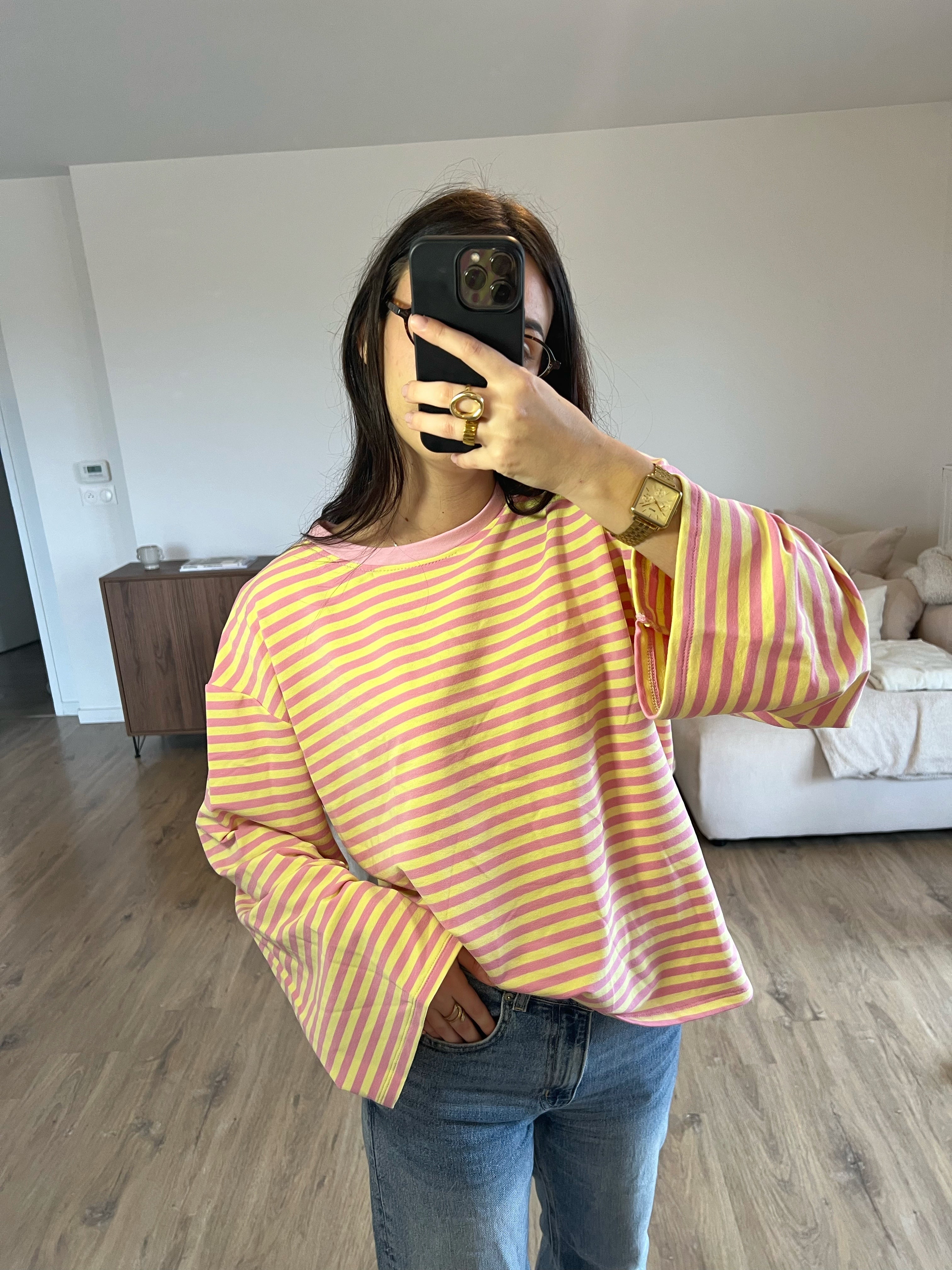 Gros plan sur les manches longues du T-shirt Dounia Oversize rayé rose clair et jaune,  confortable, style street casual printemps 2026 pour femme.